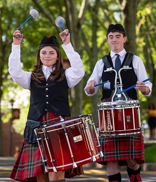 Two percussionists from the pipe band play on campus.