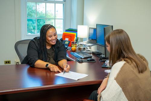 Darelle works with a student on her resume in the career center.
