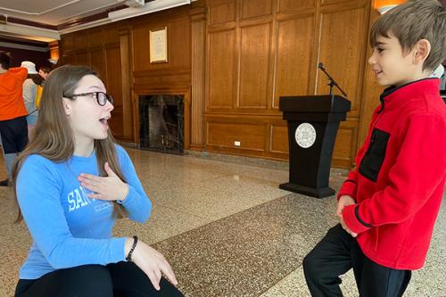 Bridget Graham showing Jack how to do sign language.