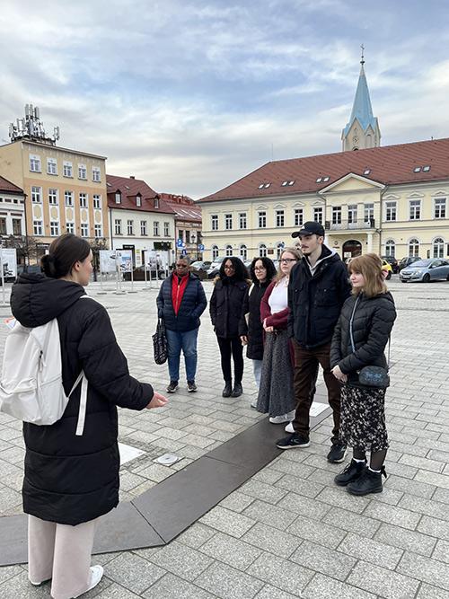 Viola Shala, an intern at the Center for Dialogue Prayer in Oswiecim, teaching Iona students and faculty about the history of Oswiecim.