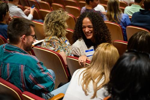 Audience members talk at the conference.