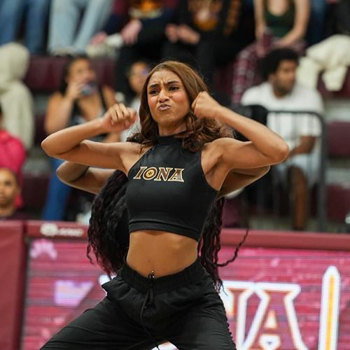Iona University Gold Line member performing a dance move at Maroon Madness event.