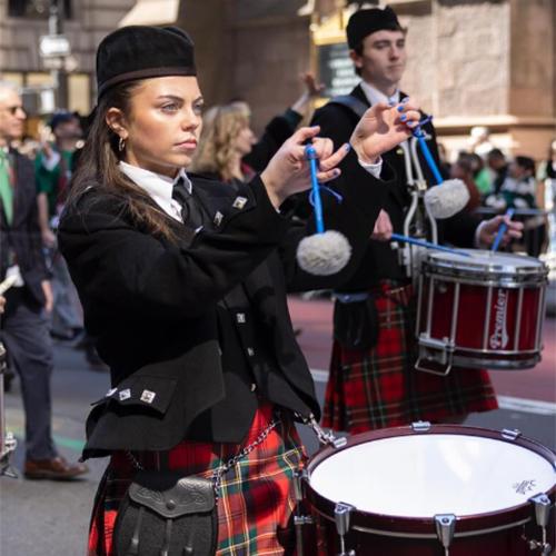Maggie Gray playing a drum in the pipe band.