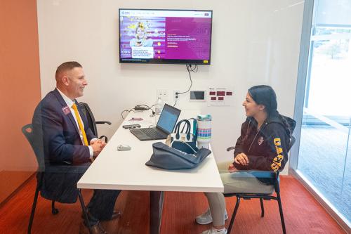 An admissions counsleor meets with a prospective student.