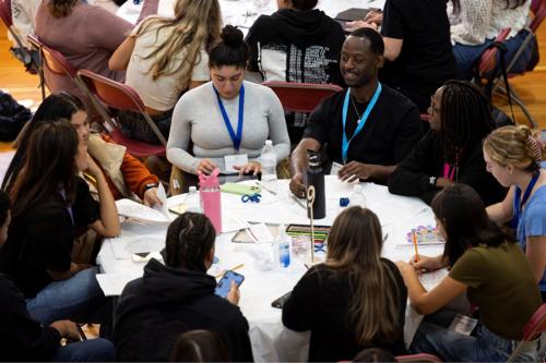 IPE students work together at a conference table.