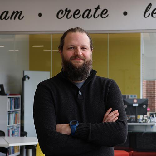 Professor Robert Kissner posing and smiling for a photo with his arms crossed.