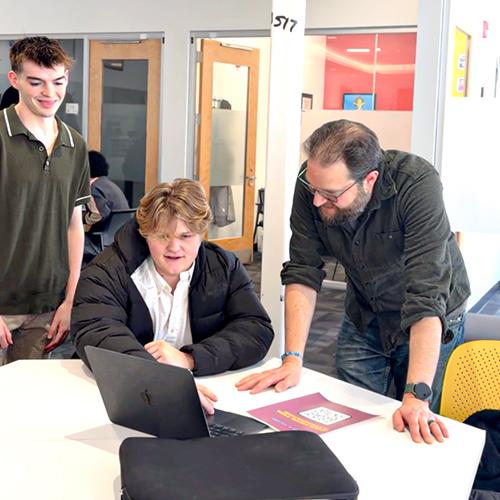 Rob Kissner works with students in the AI club.