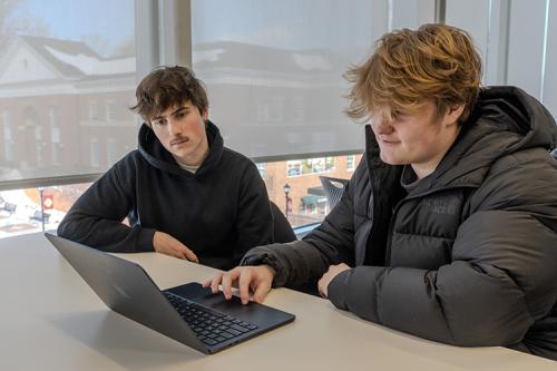 Two members of AIRL work on a project together.