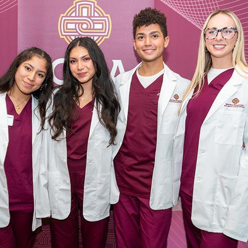 Four nursing graduates at the white coat ceremony.