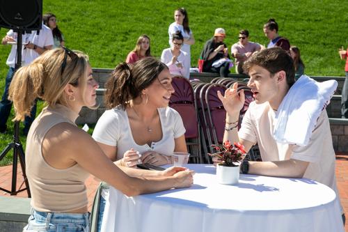 Three students conversing at the Spring Weekend Event.