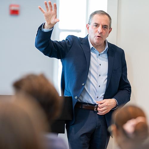 David Autor waving at the audience of the Future of Work conference.