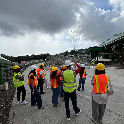 Iona students wearing safety vests and hard hats during a tour of a geothermal power plant in Dominica.
