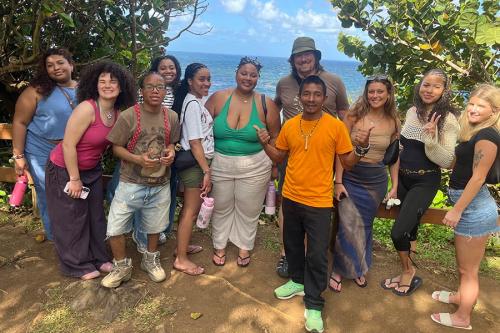 Iona students standing with a local guide on a lush hillside in the Kalinago Territory.