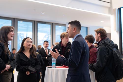 A student networking at the Mastercard C-Suite event at the LaPenta 