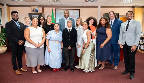 Iona University students and faculty posing for a formal group photo with Dominican Prime Minister Roosevelt Skerrit.
