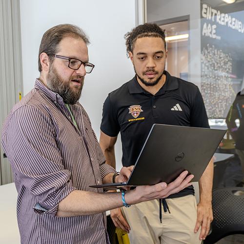 Rob Kissner works with a student for AI@Iona.