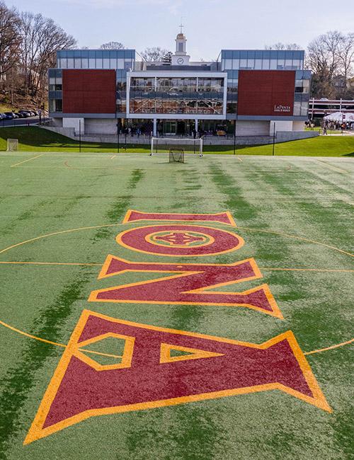 The LaPenta School of Business with Mazzella field in the foreground.