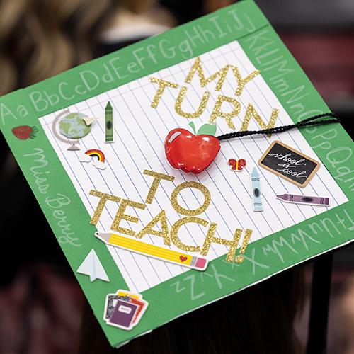 A Commencement cap that says My Turn to Teach.