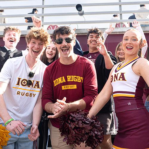 Students smile and cheer at Homecoming.
