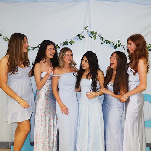 Members of Gamma Lambda Rho in formal wear at a party.