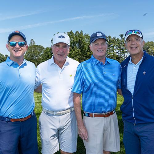 Al Kelly and three board members smile on a sunny day at Winged Foot. 