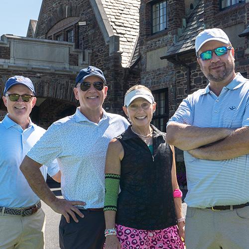 Four members of the board stand in front of the main building at Winged Foot. 