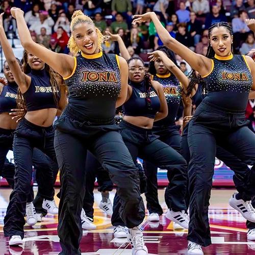 The Gold Line Team performing at a basketball game.