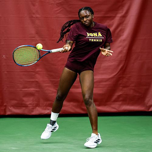 An Iona tennis player doing a jumping forehand.