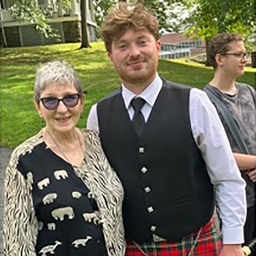 Man in Bagpipe Outfit and Woman 