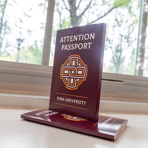 A stack of Attention Passports by the window.