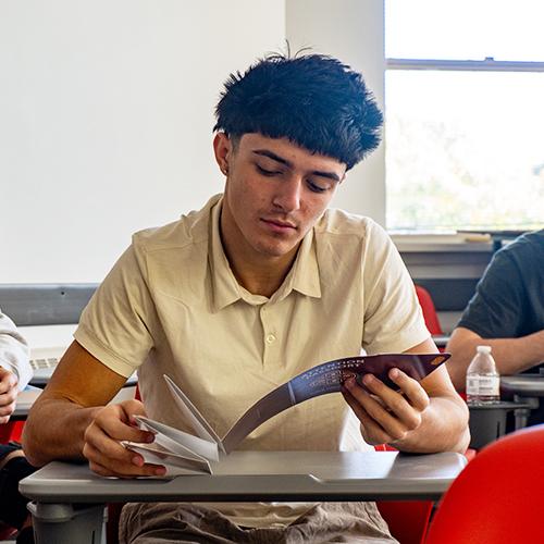A student examines his attention passport thoughtfully.