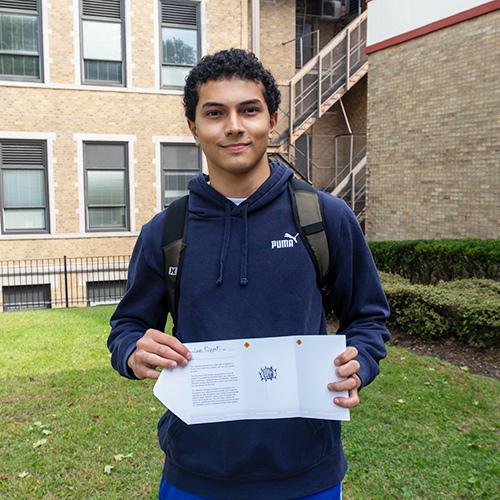 A student shows a stamp from his Attention Passport.