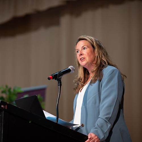 Tricia Mulligan welcomes attendees to The Future of Education conference.